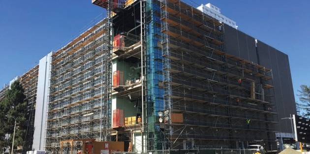 Workers putting on insulation to the exterior of SV7